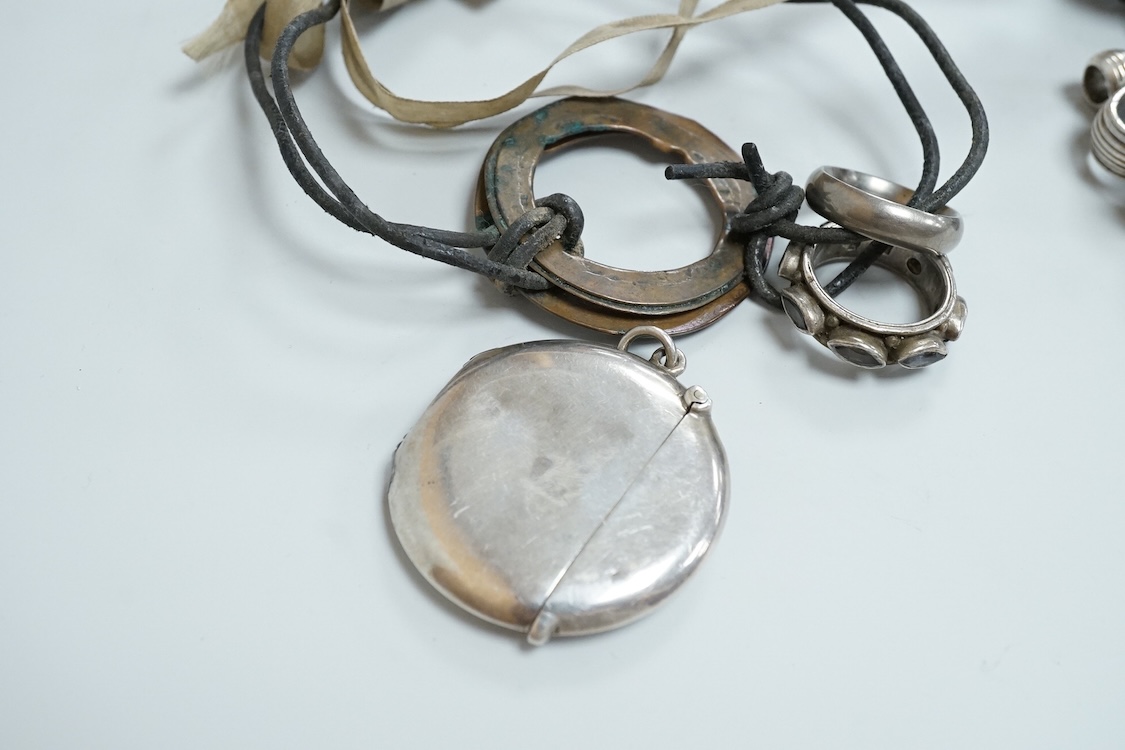 A George V silver circular vesta case, S. Blanckensee & Son Ltd, Birmingham, 43mm, together with a damaged silver child's rattle by George Unite, a cat child's rattle, white metal and lapis lazuli set fob, etc.
